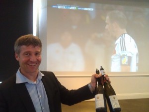 Gunter Kunstler of Weingut Kunstler celebrates a German goal in a World Cup game televised at the tasting in SF.